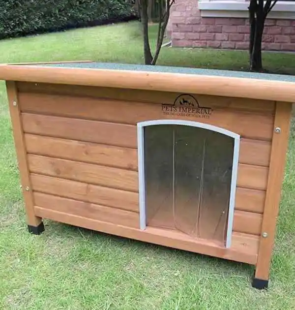 A wooden dog house with an open door, showcasing the Pets Imperial® Norfolk Insulated Dog Kennel, Size M, for outdoor use.